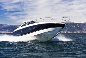 blue and white boat speeding across water